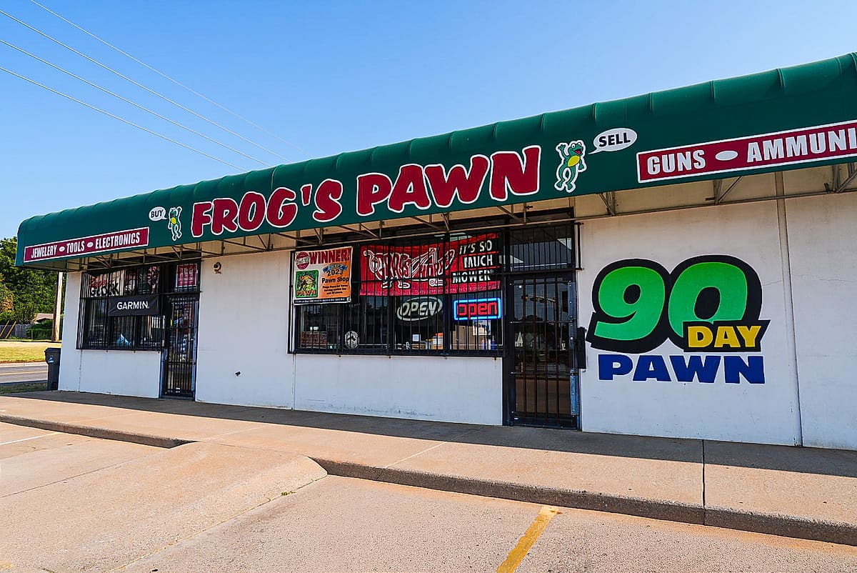 Frog's Pawn storefront under the green awning
