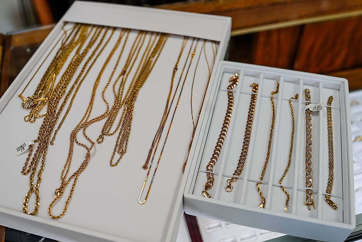 Trays of gold chains and bracelets in the jewelry case